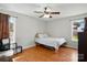 Bright bedroom with wood flooring, ceiling fan, and natural light from the surrounding windows at 2425 Barkers Ridge Dr, Bessemer City, NC 28016