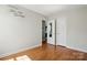Bright bedroom with wood floors, white trim, and 