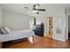 Bedroom with wood floors, ceiling fan, black dresser and ensuite bathroom access at 2425 Barkers Ridge Dr, Bessemer City, NC 28016