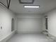 Spacious garage with painted floors, bright lighting and a convenient door to the house at 2425 Barkers Ridge Dr, Bessemer City, NC 28016