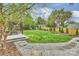 Beautiful backyard with a stone patio, lush lawn, and play area at 2529 Daniel St, Charlotte, NC 28205