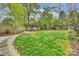 Lush backyard featuring a well-maintained lawn, mature trees, a pergola with a table and chairs at 2529 Daniel St, Charlotte, NC 28205