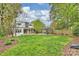 Expansive backyard with manicured lawn, pergola, patio, and landscaping for outdoor enjoyment at 2529 Daniel St, Charlotte, NC 28205