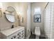 Charming bathroom features stylish vanity, modern fixtures, and a shower with patterned curtains at 2529 Daniel St, Charlotte, NC 28205