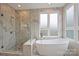 Bright bathroom showcasing a modern glass shower and standalone tub near a window at 2529 Daniel St, Charlotte, NC 28205