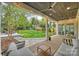 Cozy covered patio offers ample seating and a view of the spacious, well-maintained backyard at 2529 Daniel St, Charlotte, NC 28205