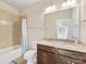 Tiled bathroom featuring dual sinks with granite countertops, a toilet, and a shower/tub combo at 266 Iverson Way, Charlotte, NC 28203