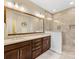 Modern bathroom with a dual sink vanity, large mirror, and a beautifully tiled walk-in shower at 266 Iverson Way, Charlotte, NC 28203