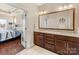 Bathroom with double vanity, granite countertops, and an open view to the Primary bedroom at 266 Iverson Way, Charlotte, NC 28203