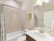 Cozy bathroom features tiled walls, a shower-tub combo, and a vanity at 266 Iverson Way, Charlotte, NC 28203