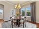 Dining room with wood table and seating for four plus windows providing ample natural light at 266 Iverson Way, Charlotte, NC 28203