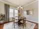 Dining area with wood table and seating for four, bathed in natural light, perfect for Gathering gatherings at 266 Iverson Way, Charlotte, NC 28203