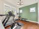 Bright exercise room with modern lighting, hardwood floors, and fitness equipment at 266 Iverson Way, Charlotte, NC 28203