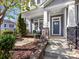 Inviting front porch with stone accents, a cozy cushioned bench, manicured landscaping, and clear address signage at 266 Iverson Way, Charlotte, NC 28203