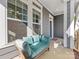 Relaxing front porch area with a comfortable cushioned bench, natural light, and clear view of the home's address at 266 Iverson Way, Charlotte, NC 28203