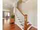 Hallway with hardwood floors, white trim, and an open view to the dining room at 266 Iverson Way, Charlotte, NC 28203