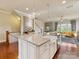 Kitchen island with a white farmhouse sink, granite countertops, and pendant lighting at 266 Iverson Way, Charlotte, NC 28203