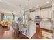 Open concept kitchen with a large island, barstool seating, and modern appliances flowing into the living area at 266 Iverson Way, Charlotte, NC 28203