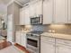 Well-equipped kitchen with stainless steel KitchenAid appliances, granite countertops, and gray tile backsplash at 266 Iverson Way, Charlotte, NC 28203