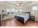 Bright main bedroom featuring hardwood floors, large windows, and a tray ceiling at 266 Iverson Way, Charlotte, NC 28203