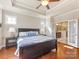 Main bedroom with hardwood floors, a tray ceiling, and an ensuite bathroom at 266 Iverson Way, Charlotte, NC 28203