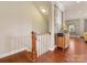 Elegant staircase with hardwood floors, white railings, and a view of tasteful home decor leading to an upper level at 266 Iverson Way, Charlotte, NC 28203