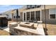 This backyard boasts a stone fire pit, covered patio and well manicured lawn at 2768 Suffolk Pl, Fort Mill, SC 29715