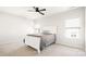 Well-lit bedroom with a ceiling fan, queen sized bed, carpet flooring, and natural light at 2768 Suffolk Pl, Fort Mill, SC 29715