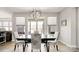 Beautiful dining area with lots of windows and an elegant light fixture at 2768 Suffolk Pl, Fort Mill, SC 29715