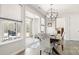 Dining room with a modern chandelier, large windows, and a view of the patio at 2768 Suffolk Pl, Fort Mill, SC 29715