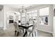 Bright dining room with a stylish chandelier and large windows overlooking the backyard at 2768 Suffolk Pl, Fort Mill, SC 29715