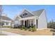 Charming two-story home featuring stone accents, a covered porch, and a well-manicured lawn at 2768 Suffolk Pl, Fort Mill, SC 29715