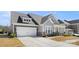Charming two-story home featuring stone accents, a covered porch, and a well-manicured lawn and two-car garage at 2768 Suffolk Pl, Fort Mill, SC 29715