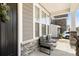 Inviting front porch with stone columns, seating, and a view of the neighborhood at 2768 Suffolk Pl, Fort Mill, SC 29715