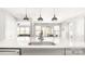 Modern kitchen featuring stainless steel appliances, sleek white countertops, and contemporary pendant lighting at 2768 Suffolk Pl, Fort Mill, SC 29715