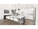 Kitchen featuring white cabinets, a large island with seating, and stainless steel appliances at 2768 Suffolk Pl, Fort Mill, SC 29715