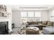 Comfortable living room with a fireplace, gray sectional, and lots of natural light at 2768 Suffolk Pl, Fort Mill, SC 29715