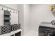 Mud room area featuring a bench with storage, coat hooks, and patterned tile floor at 2768 Suffolk Pl, Fort Mill, SC 29715