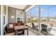 Inviting sunroom with comfortable seating, a table for dining, and panoramic backyard views through expansive windows at 2768 Suffolk Pl, Fort Mill, SC 29715