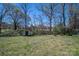 Exterior view of a large backyard with a shed and a chain-link fence at 300 Bell St # 80, Mount Holly, NC 28120
