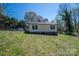 Exterior view of a home with a fenced backyard showing the vinyl siding and garden area at 300 Bell St # 80, Mount Holly, NC 28120