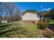 Exterior view of a charming home featuring a fenced yard and a detached shed for additional storage at 300 Bell St # 80, Mount Holly, NC 28120