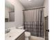 This bathroom features a gray shower curtain, a sink with chrome fixtures, and a mirrored medicine cabinet at 300 Bell St # 80, Mount Holly, NC 28120