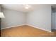 A simple bedroom featuring hardwood floors, neutral paint, ceiling fan, and a closet door at 300 Bell St # 80, Mount Holly, NC 28120
