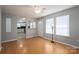 Bright living room with hardwood floors, natural light, and a view into the updated kitchen at 300 Bell St # 80, Mount Holly, NC 28120