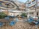 Courtyard with outdoor seating areas, blue umbrellas, landscaping, and a water feature at 301 E Tremont Ave, Charlotte, NC 28203