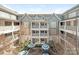 Exterior view of a building showcasing a courtyard with outdoor seating and architectural details at 301 E Tremont Ave, Charlotte, NC 28203