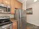 Efficient kitchen featuring stainless steel appliances and wooden cabinetry at 301 E Tremont Ave, Charlotte, NC 28203