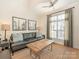 Comfortable living room featuring a ceiling fan, large window, and stylish furnishings at 301 E Tremont Ave, Charlotte, NC 28203