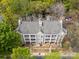 Birds-eye view of a multi-story building with a gray roof surrounded by mature trees and parking at 306 S Cedar St # 10, Charlotte, NC 28202